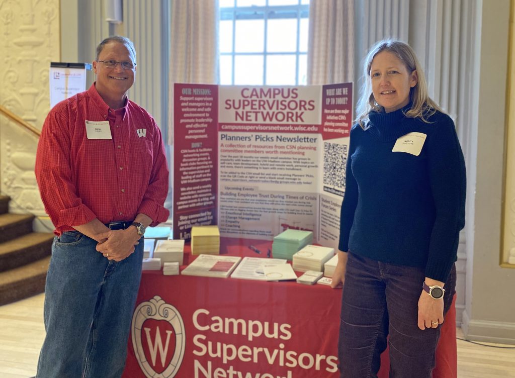 Rich Gassen and Nancy Kujak-Ford standing at their display booth at Memorial Union Leadership @ UW event 4/27/22