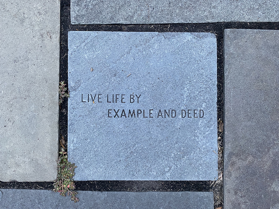 Stepping Stone with “Live Life By Example and Deed” engraved on it.