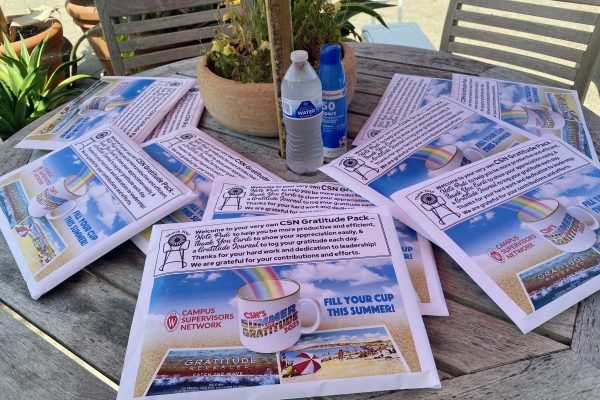A bunch of CSN Gratitude Packs on an outdoor table in the shade at Allen Centennial Gardens on UW-Madison Campus.