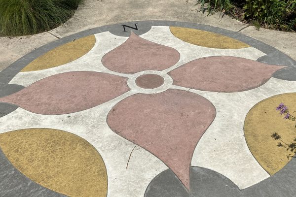 A large compass is designed in the pavement at Allen Centennial Gardens on UW-Madison Campus.